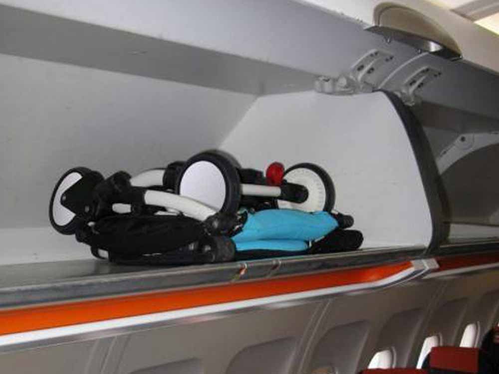 YOYO Babyzen 6+stroller folded in the compartment suitcase cabin of an airplane