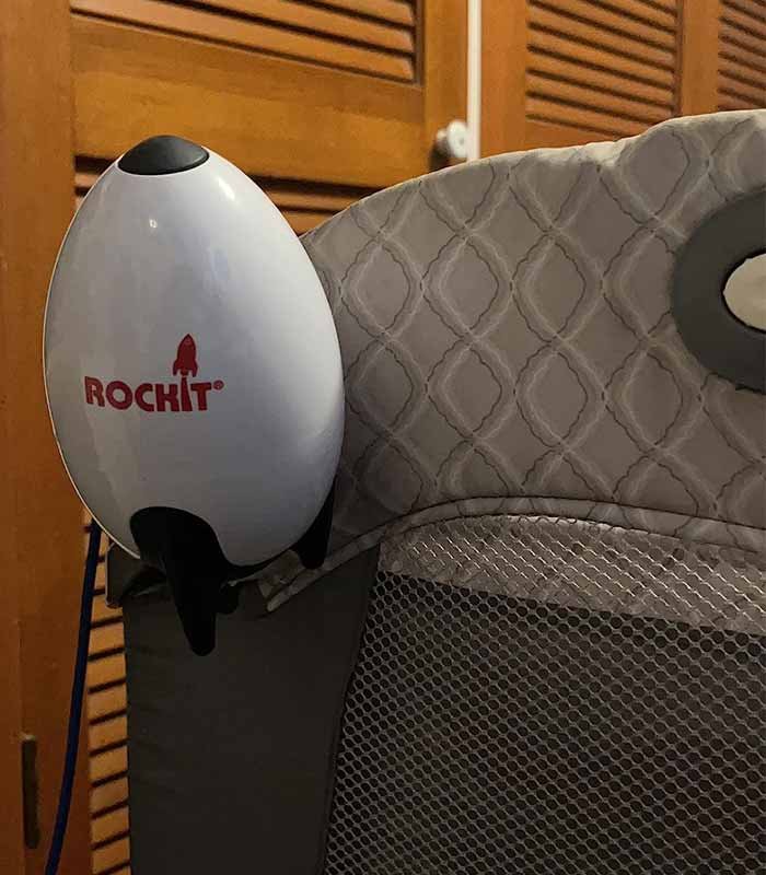 Automatic rocking stroller ROCKIT installed on a travel cot