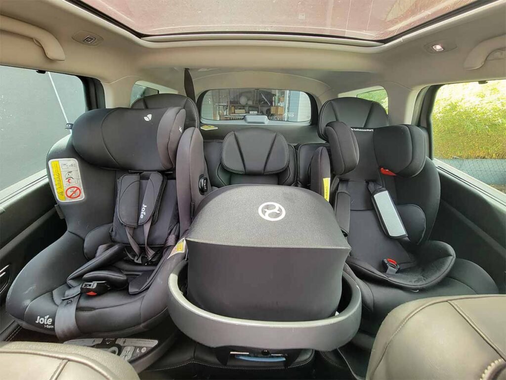 3 different car seats installed in the rear of the large renault scenic